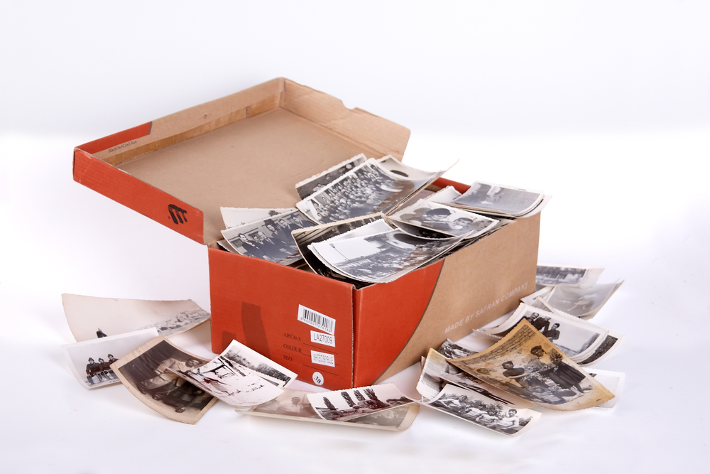 A full box of old photos, clipping path, focus on front