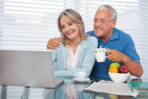 Happy couple using laptop