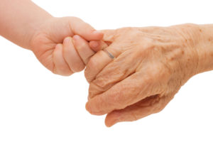 Toddler holding great grandmas hand